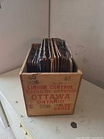Side of crate showing Liquor Control Board of Ontario Ottawa text and stack of records inside