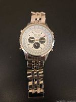 Front view of stainless steel Breitling-marked wristwatch with bracelet