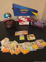 Overview showing display box, tins, empty product boxes and spread of trading cards