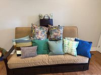 All nine throw pillows positioned on couch for full view