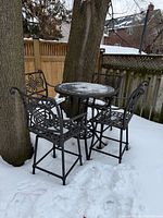 Full view of table and four chairs showing design and condition