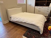 White faux leather double bed with mattress, side view