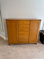 Front view of dresser showing two side doors and six center drawers