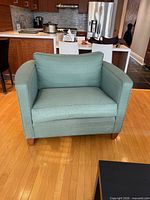 Front view displaying overall chair shape, upholstery, and condition