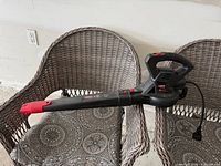 Full view of Legend Force corded leaf blower resting on chair, shows overall condition and design