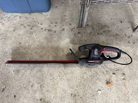 Full view of hedge trimmer showing entire length and cord