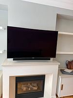 Front view of LG 55-inch curved OLED TV on stand