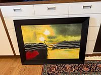 Full framed print leaning against cabinet