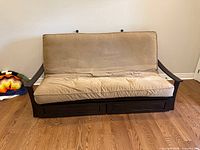 Front view of futon showing frame, cushions, drawers