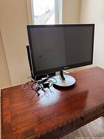 Front view of Samsung 27-inch monitor on stand with cables