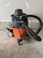 Full view of Shop-Vac showing body, hose, caster base
