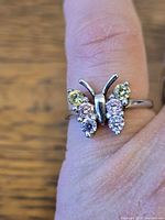 Close-up of butterfly cubic zirconia design on finger