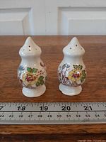 Front view of both shakers beside ruler