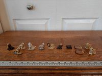 Line-up of all twelve Wade Whimsies with ruler for scale