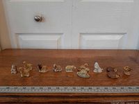 All twelve figurines lined up with ruler for scale