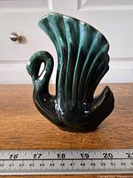 Front view of Blue Mountain Pottery swan vase with ruler for scale