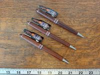 Three Budweiser pens with ruler for scale