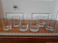 Front view of six clear glass tumblers lined up