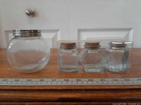 All four jars with ruler for scale