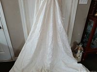 Full length view of dress showing brocade fabric and long train