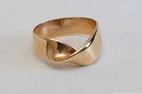 Front view showing twisted design and yellow gold tone