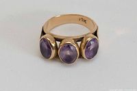 Front view showing three amethyst stones and gold band