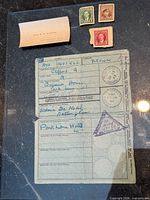 Identity card, calling card and three stamps laid out together