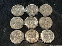 Nine Canadian 50 cent coins arranged in three-by-three grid
