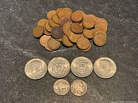 Grouped view of 54 Wheat pennies, 4 Kennedy halves, 2 Buffalo nickels