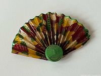 Front view of multicolour celluloid fan brooch