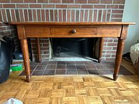 Full view of pine table against brick background