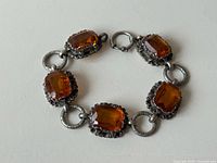 Full bracelet laid flat displaying stones and links