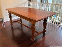 Full view of table with leaf down showing turned legs and stretcher