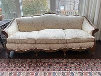 Full front view of sofa showing upholstery, frame and overall condition