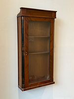 Front view of mahogany wall cabinet with glass door