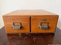 Front view showing two drawers, oak grain, brass pulls