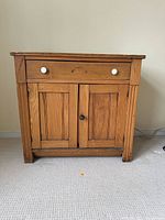 Front view of entire pine washstand cabinet showing drawer, doors, and hardware