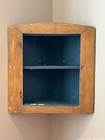 Front view of pine corner cupboard showing shape and missing door