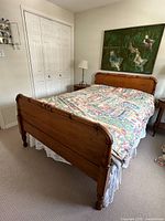 Full view of assembled antique turned wood double bed frame with mattress for scale