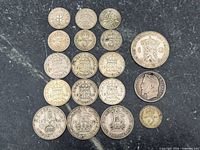 All 18 coins laid out showing obverse or reverse designs