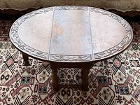 Top view showing oval shape, carved edge detail, surface wear