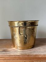 front view of hammered brass planter showing rope twist trim