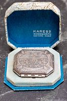 Compact inside original box showing branding