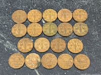 All 19 Canadian 5 cent tombac coins laid out reverse side up