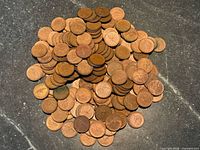 Pile of mixed 1967 Canadian cents on stone surface