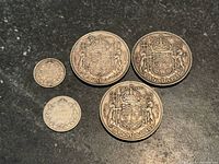 All five coins laid out showing obverse design and dates