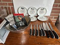 Overall lot view showing knives, books, fruit bowl and plates