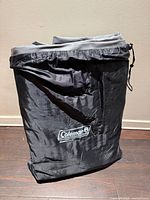 Black drawstring storage bag with white Coleman logo