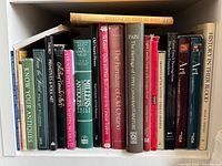 Shelf left side showing titles on log houses, docks, antiques, folk art