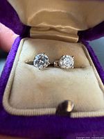 Front view of both diamond studs in box